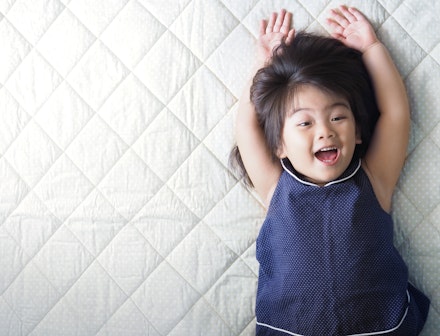 toddler on mattress bed