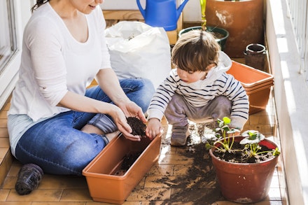 woman planting with child