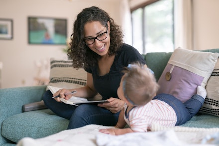 woman writing with baby