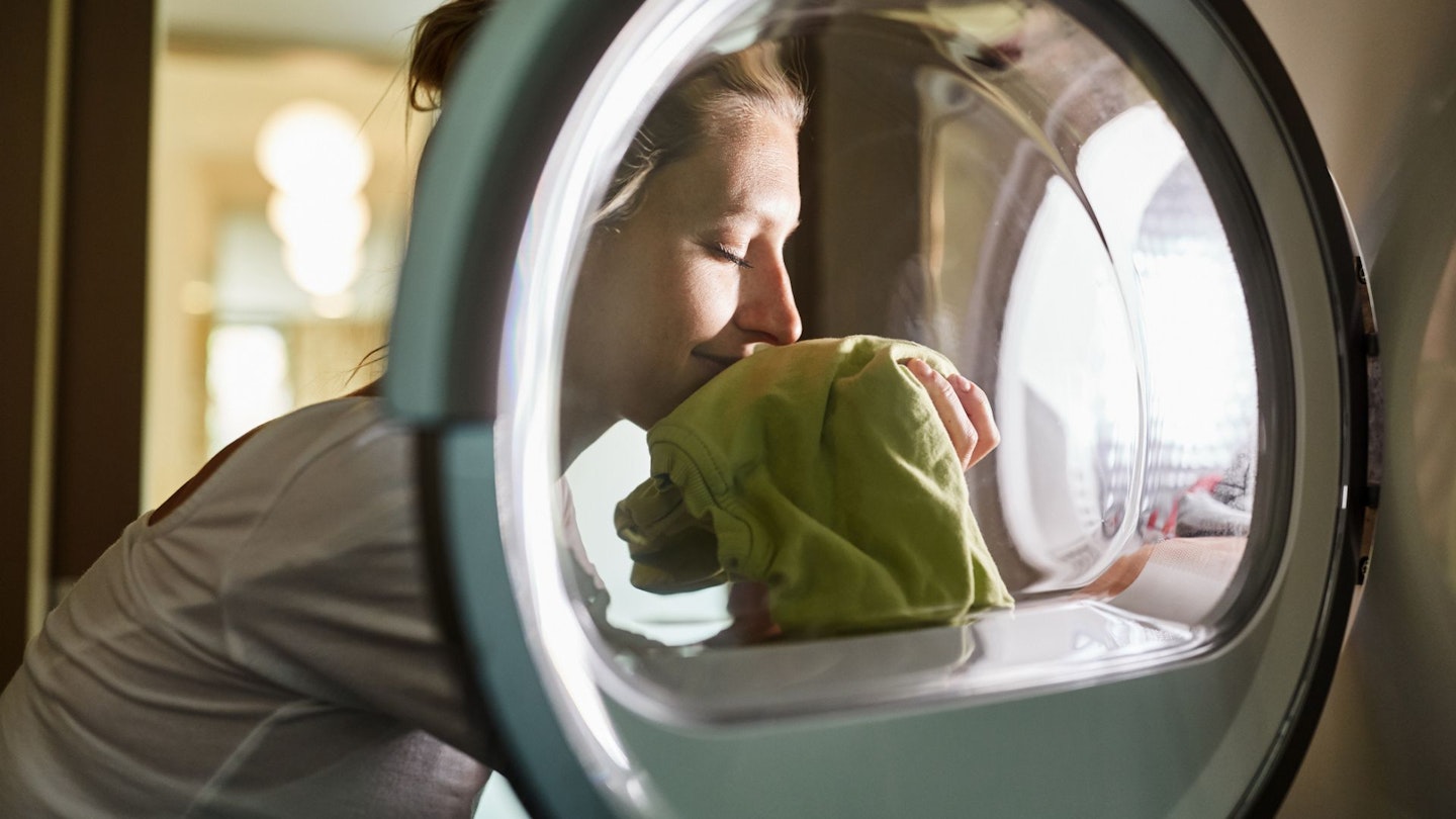 Woman smelling clean clothes
