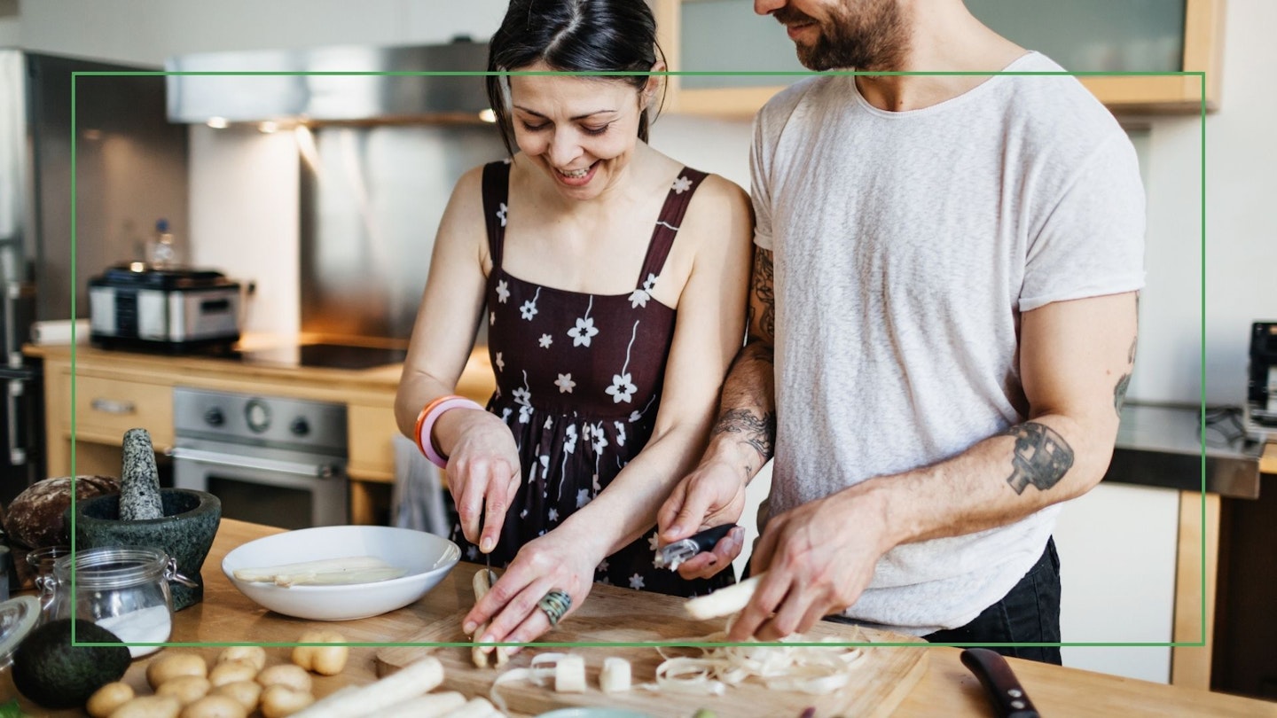 Couple using chopping board to prepare food