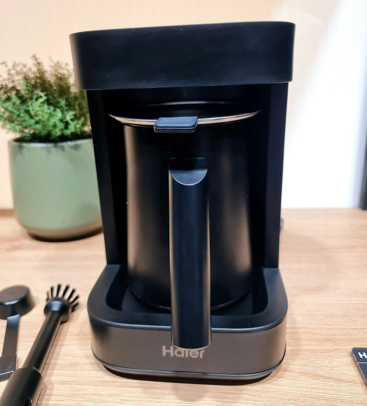 Haier Multi Beverage Maker on a wooden surface