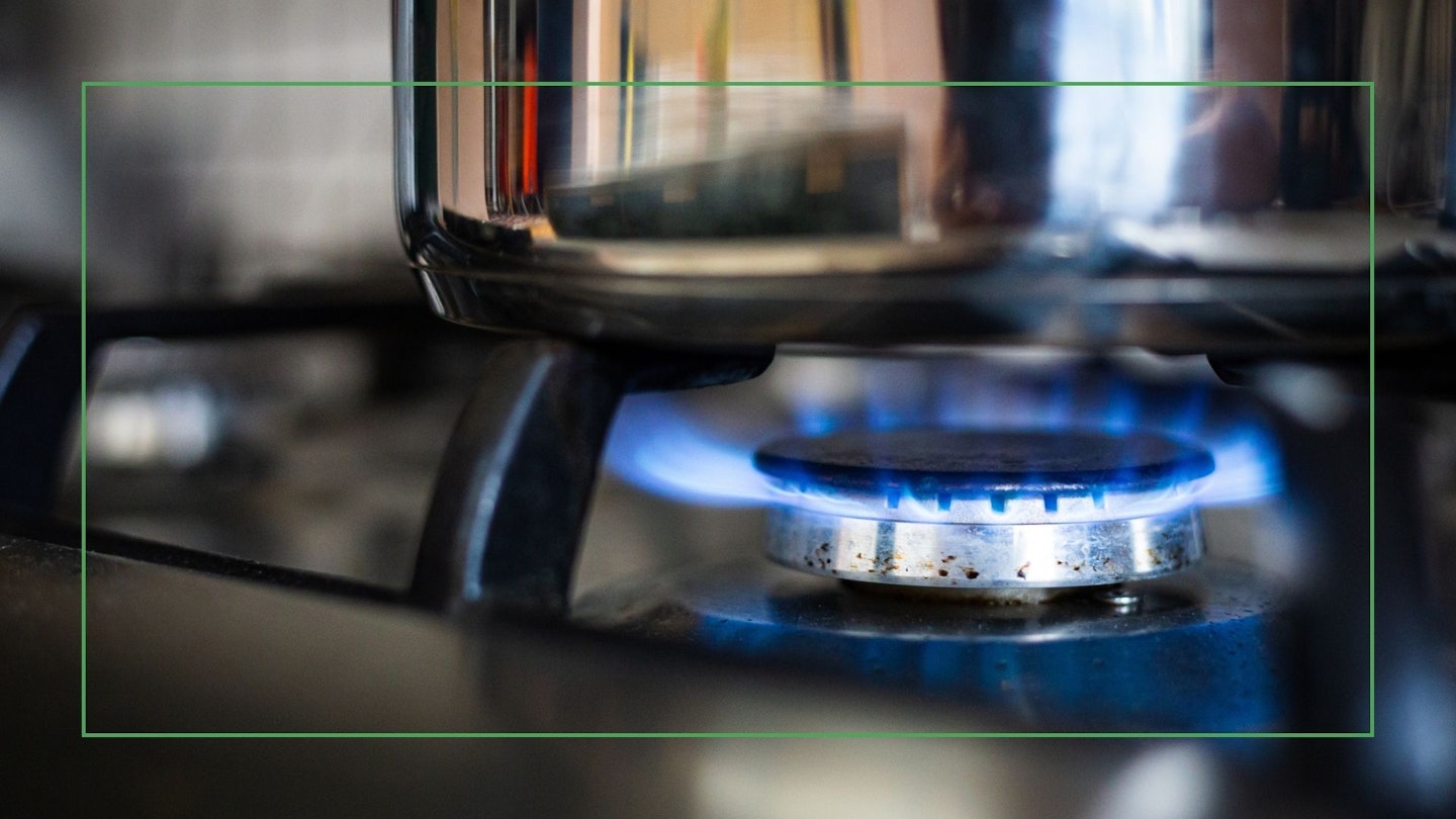 Close up colour image depicting a cooking pan on a gas hob with blue flames in the kitchen. Best pans for a gas stove