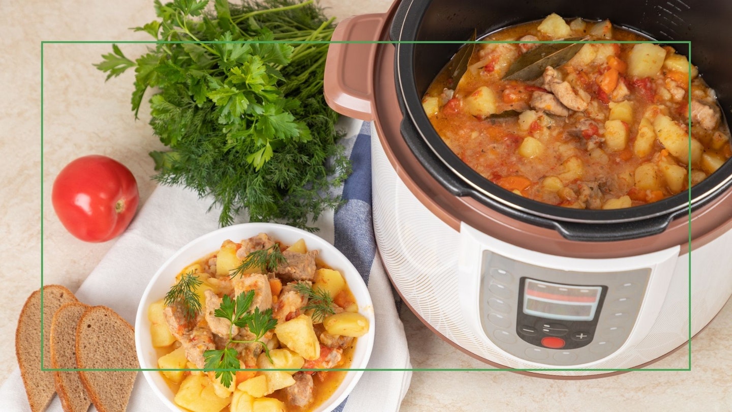 A multicooker with food being served from it