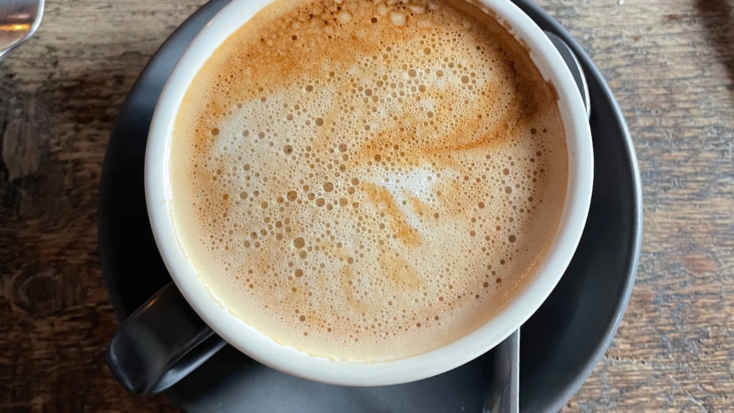 Oat latte on a wooden table