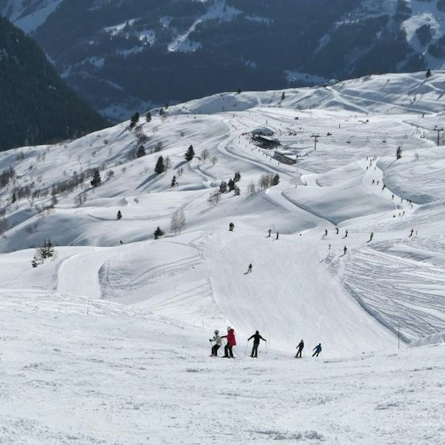 Skiers on the slopes at La Rosiere, France with mountains in the background