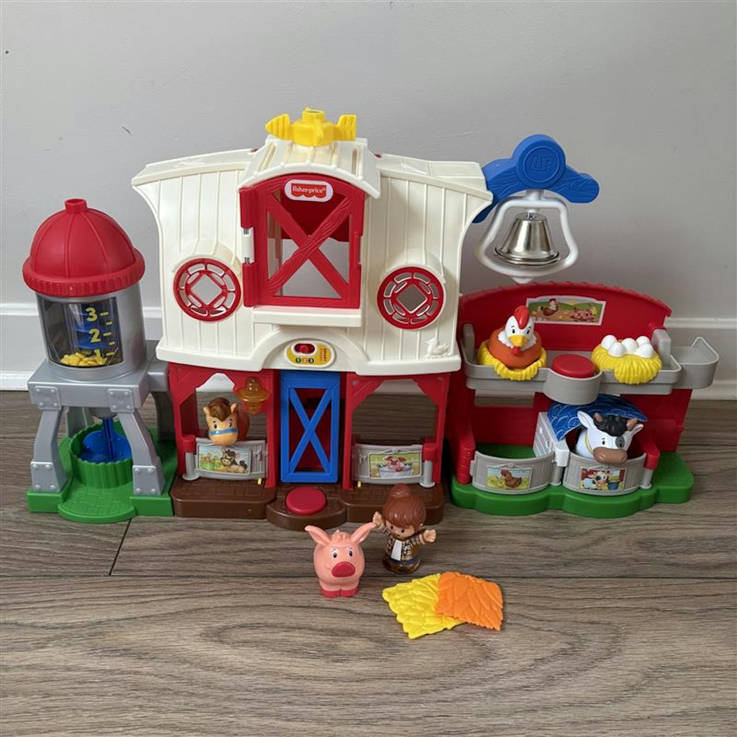 fisher price farm yard toy sitting in a house against a wall