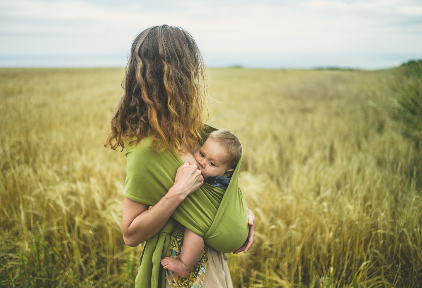 Mother breastfeeding in a sling