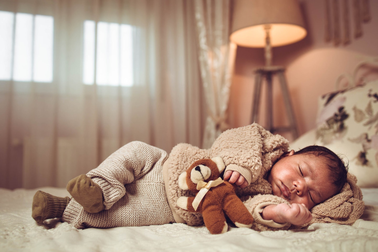 baby sleeping on a bed.