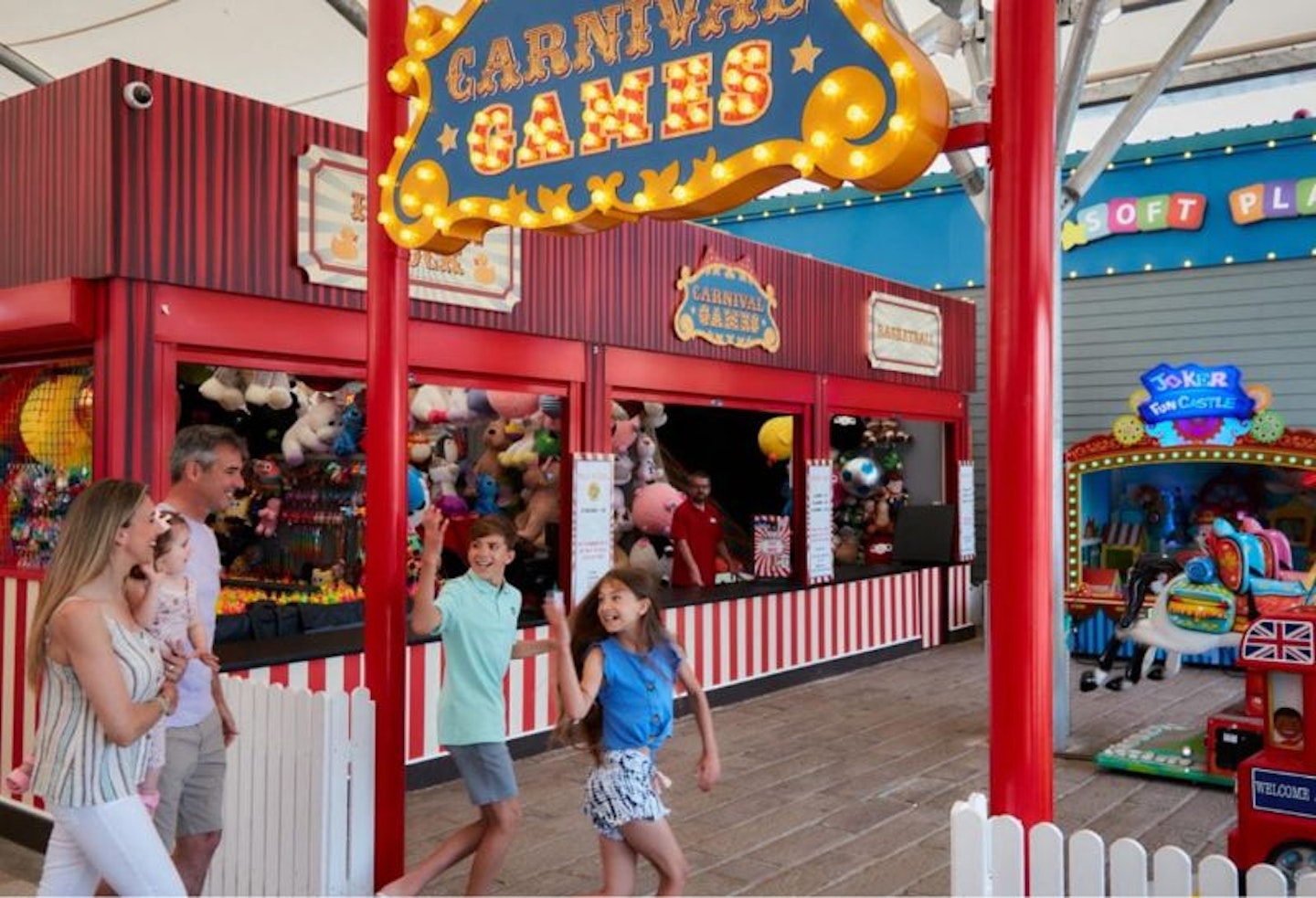 Children walking into an entertainment arcade at Parkdean Trecco Bay Holiday Park