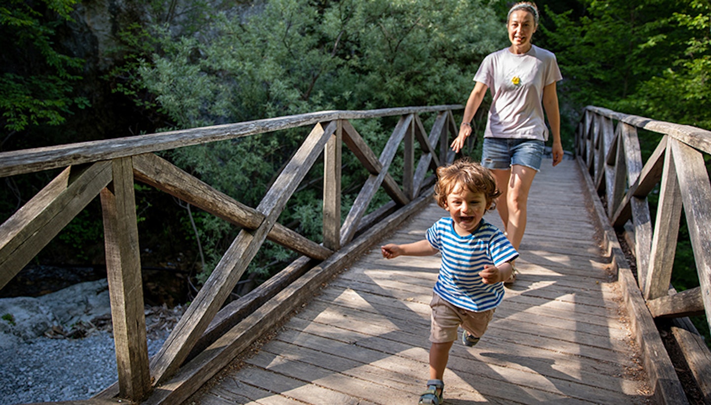 Playful toddler having fun during family hike