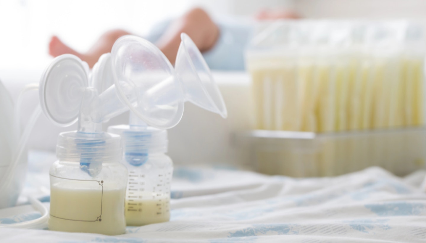 Breast milk frozen in storage bag and baby lying on background