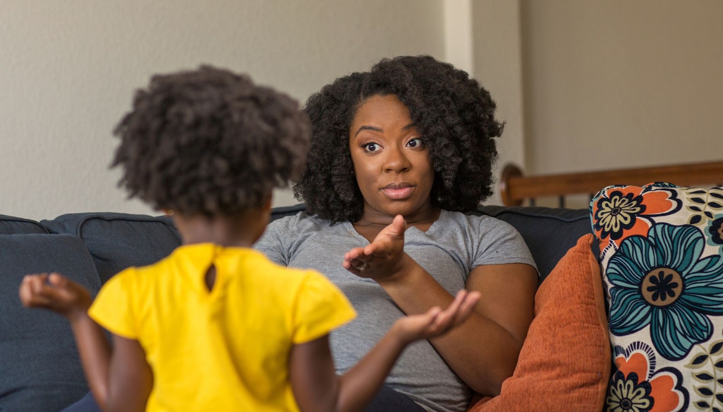 African American mother disciplining parenting her young child.