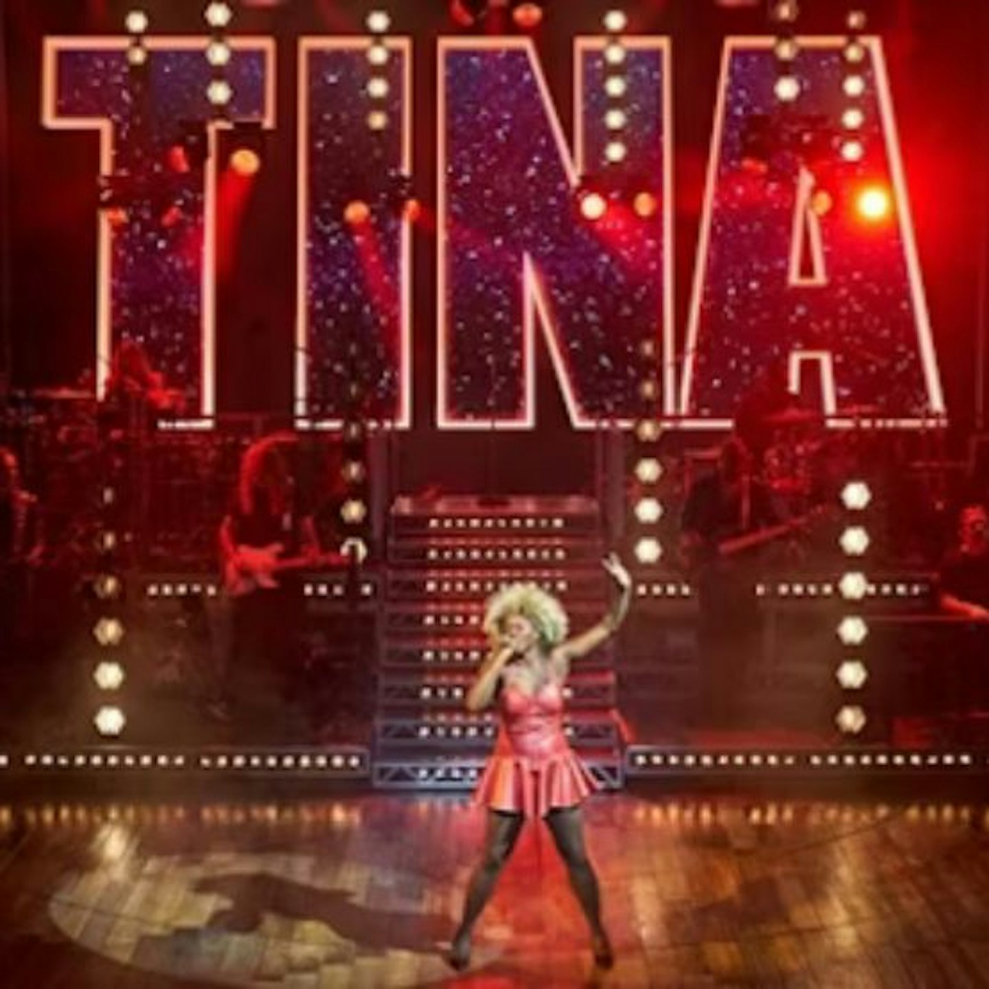 A shot of Tina Turner the musical with 'tina' singing on stage and lights beyond spelling out TINA