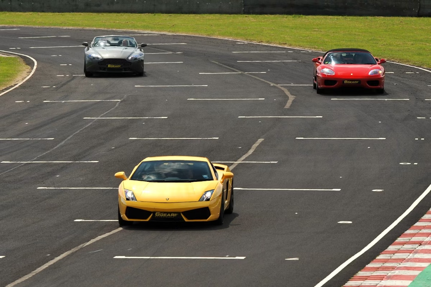 Three supercars driving on a track