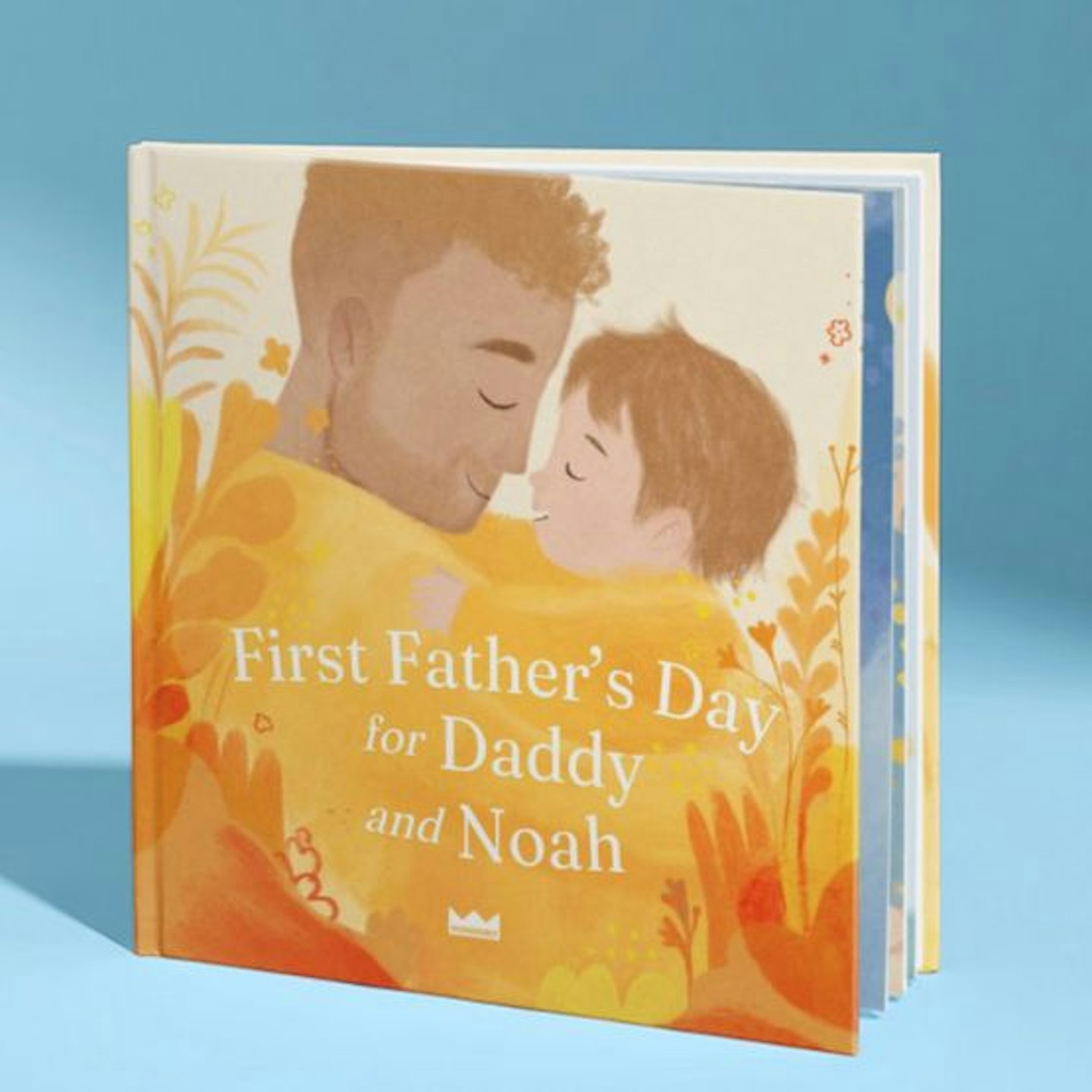 A personalised book called First fathers day for daddy and Noah, showing a father and son hugging