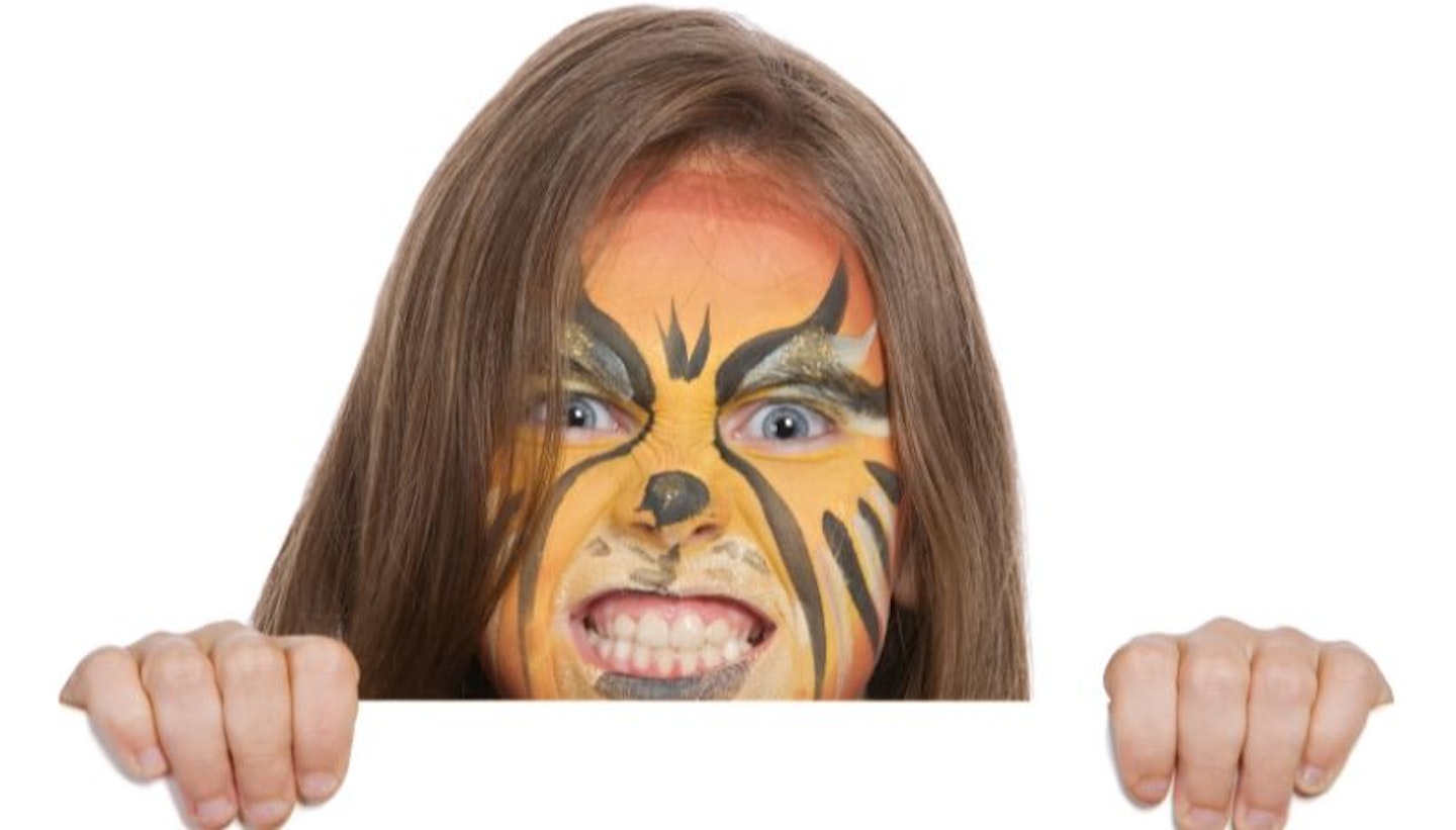 A girl with a lion Halloween face paint