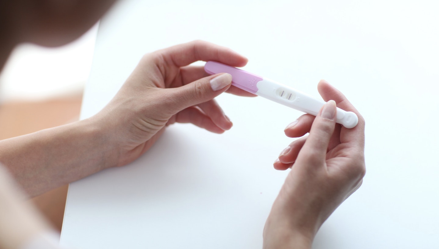 woman holding pregnancy test in her hands