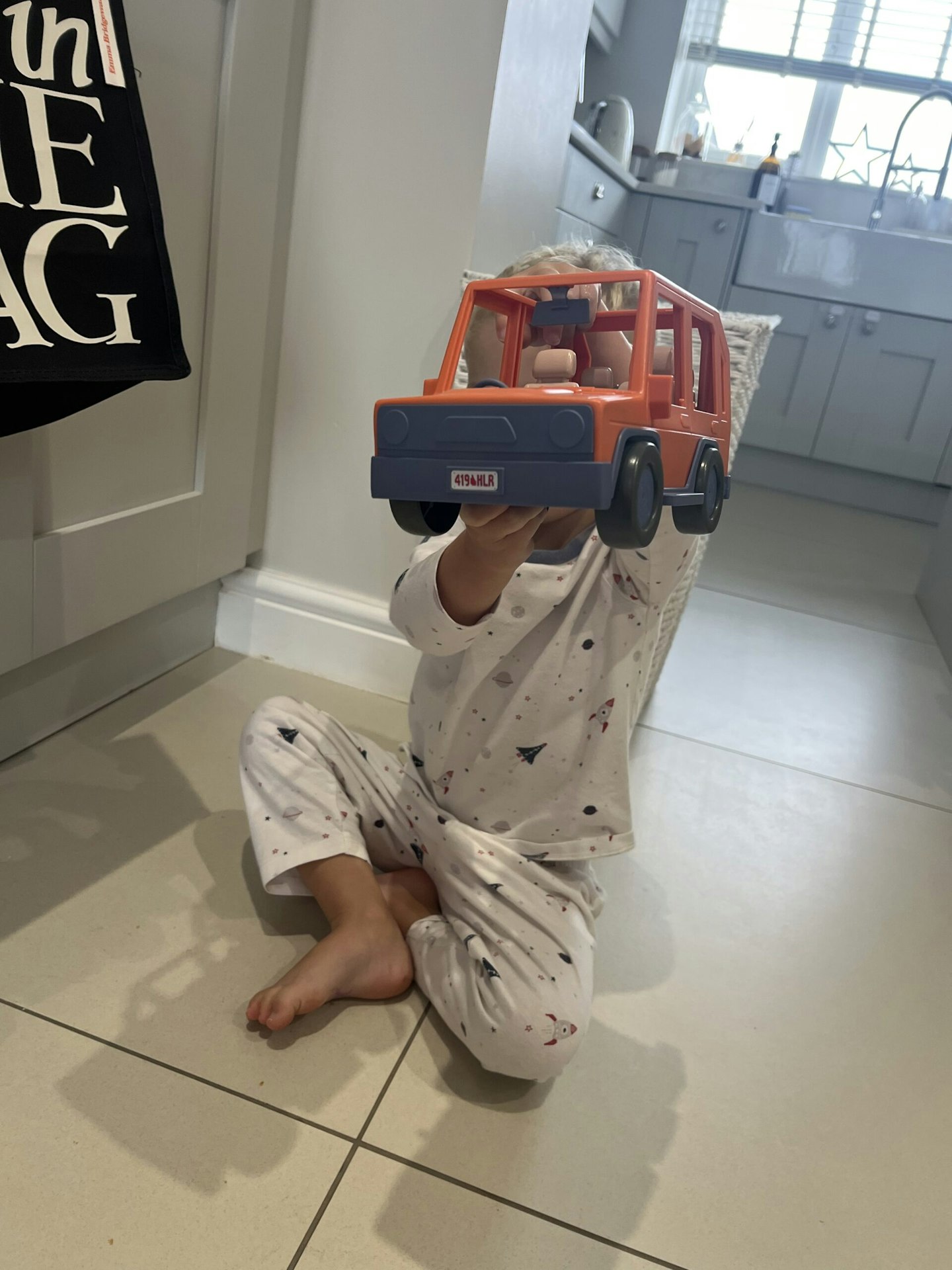 Child playing with 4WD Bluey truck