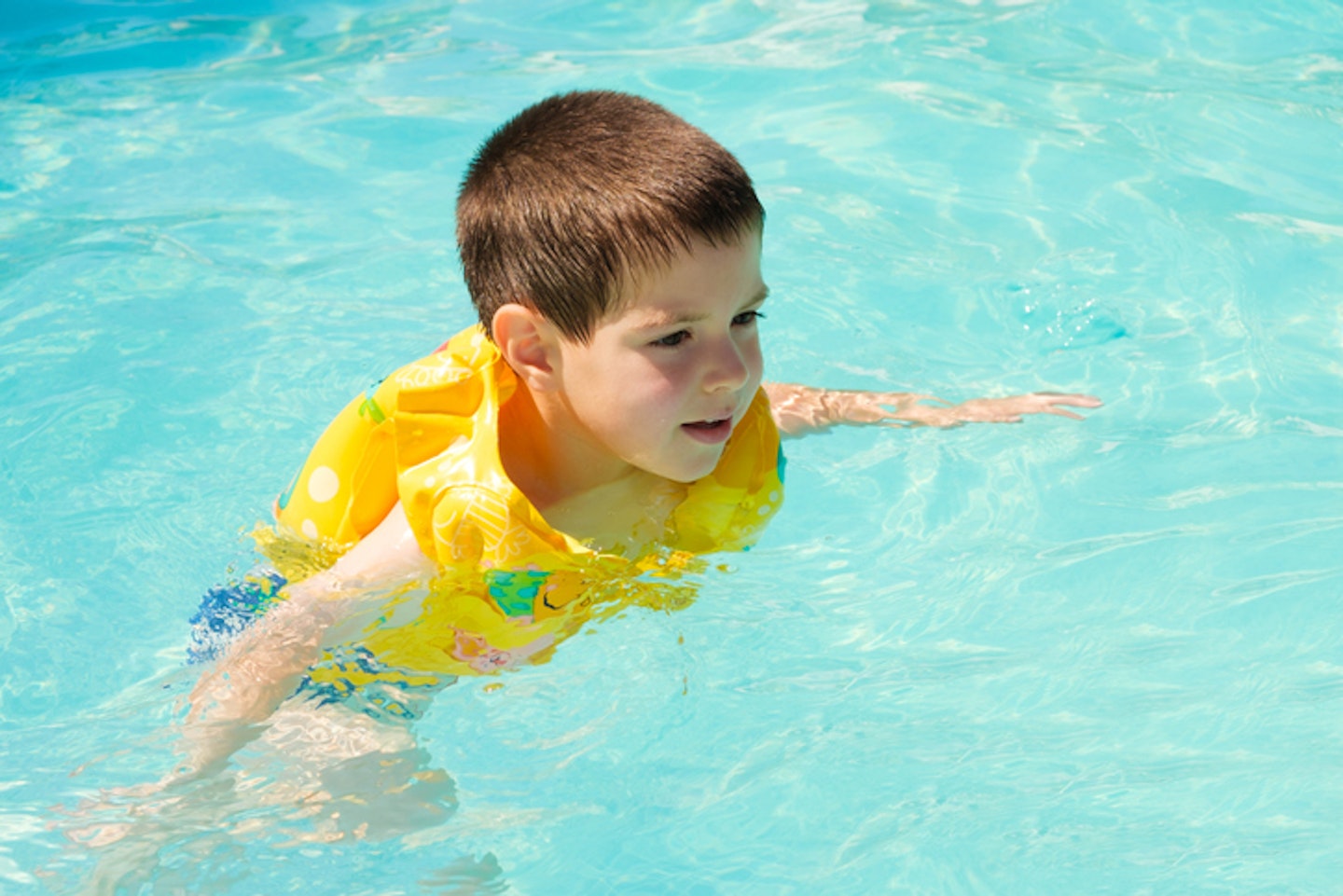Little boy wearing swim vest