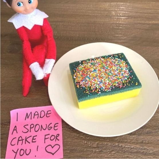 An elf with a washing up sponge and sprinkles on top, with a post it note saying 
