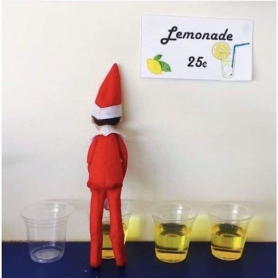 An elf standing with its back to the camera and glass cups full of yellow liquid