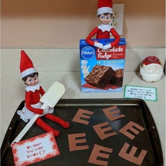 Elves with a baking sheet covered in 