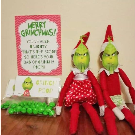 Two elves dressed up as the grinch