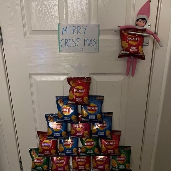 An elf taped to the door with a 