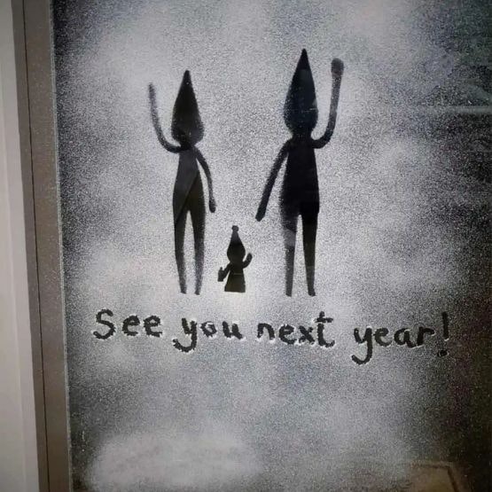 Silouettes of elves leaving on a door with snow around