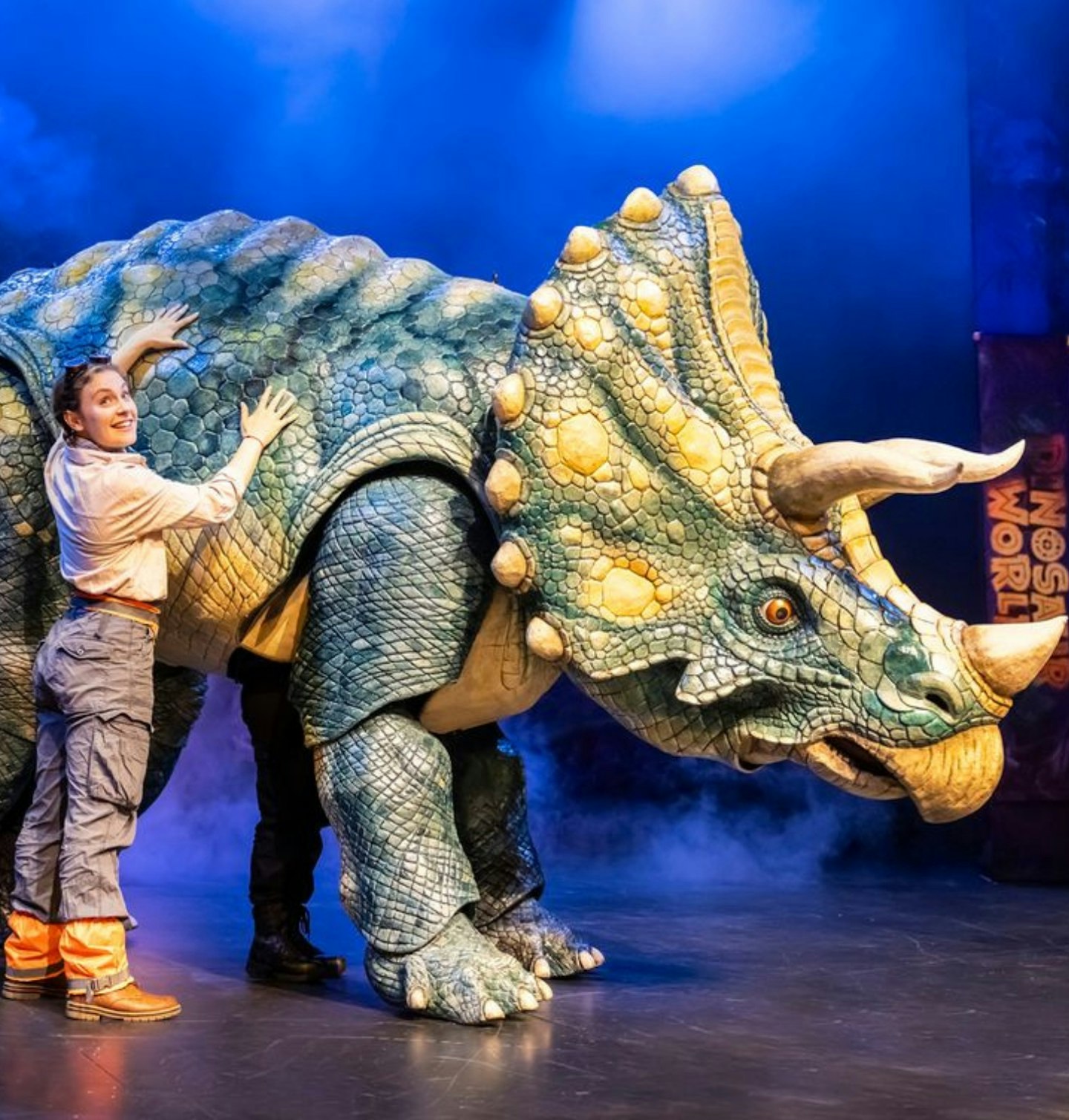 Actress performing with with a dinosaur at Dinosaur World Live