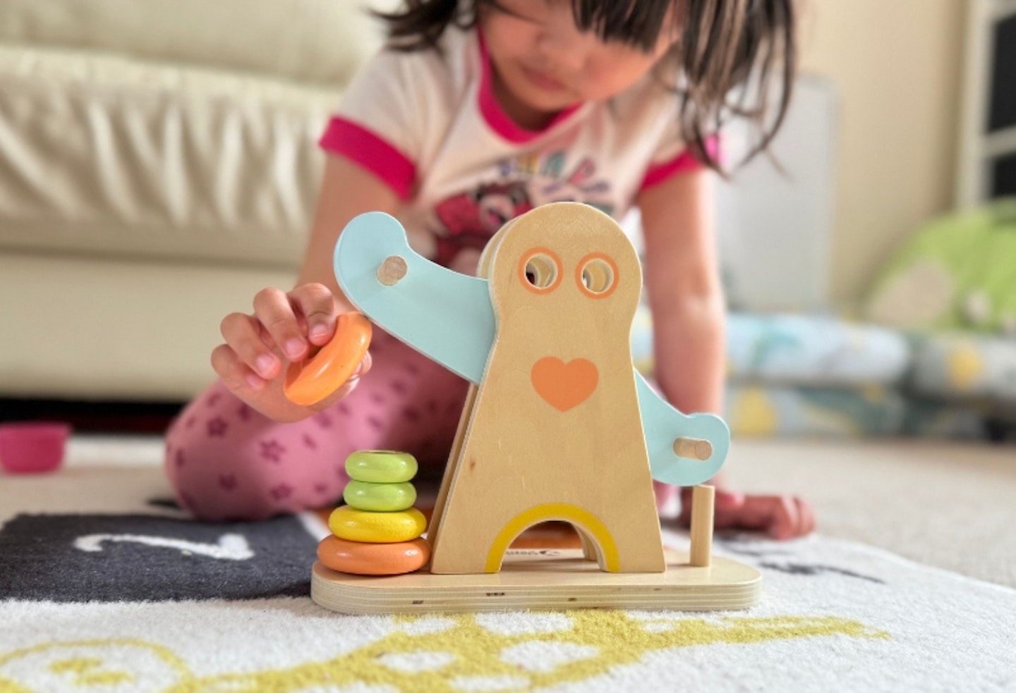 young girl playing with the Hippychick Classic World Hercules Weightlifting toy