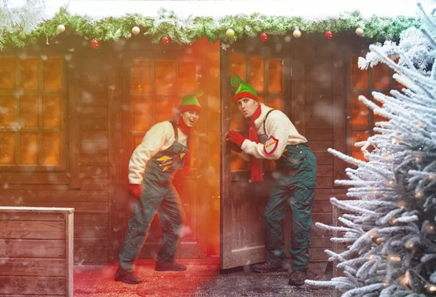 Two elves outside a festive doorway