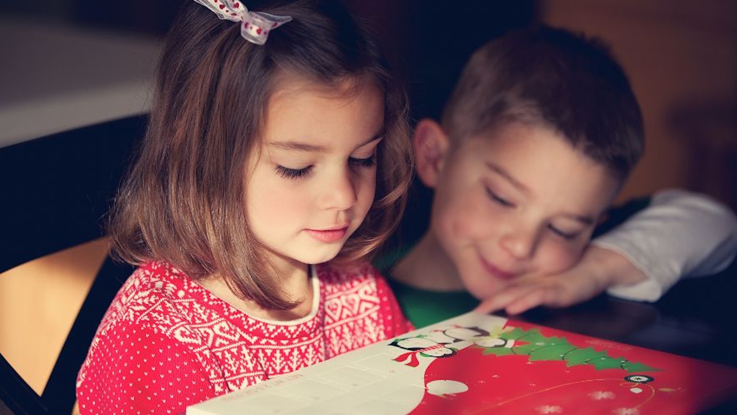 Two children looking at a chocolate Advent calendar for kids