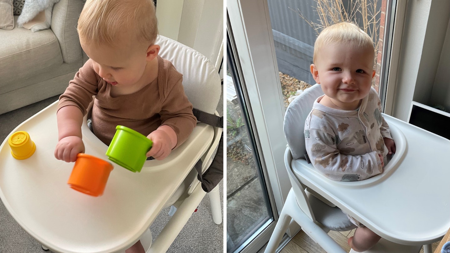 A baby in the Bugaboo Giraffe playing with stacking cups and smiling.