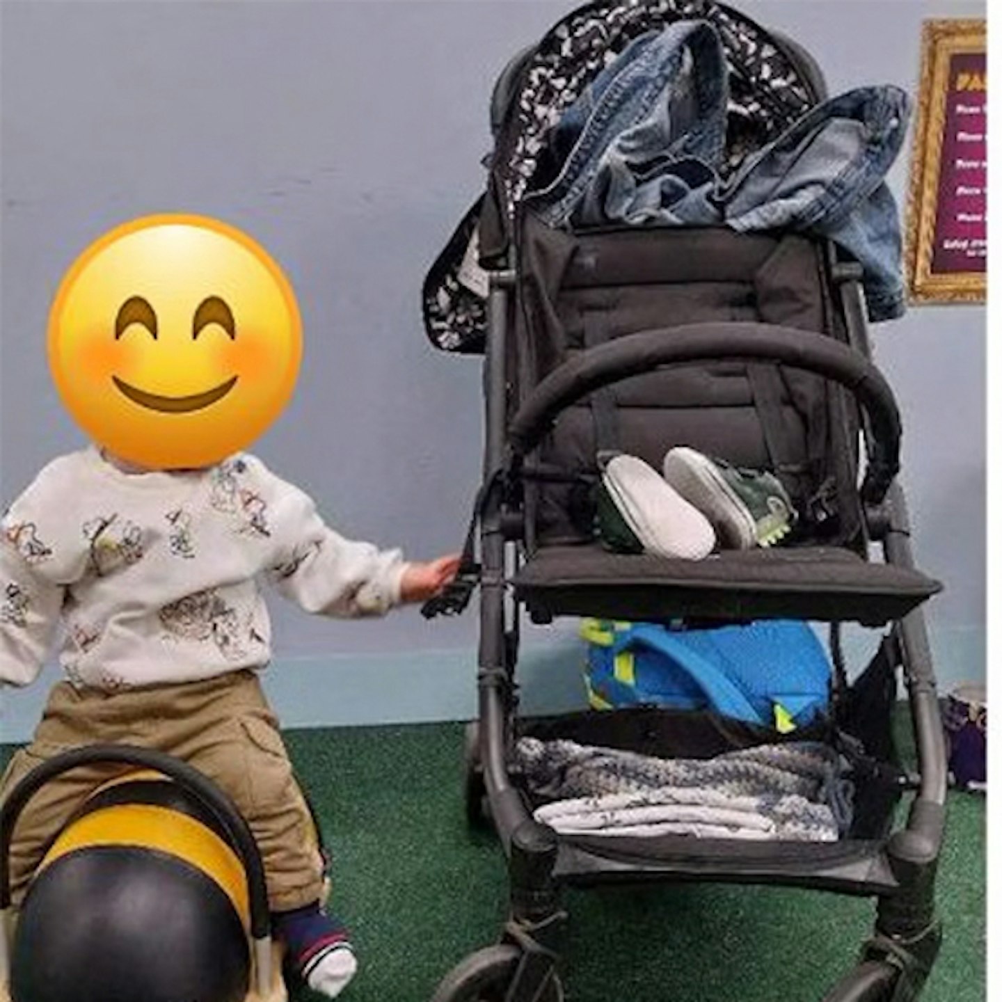 Black Cosatto Yo pictured with a toddler while travelling fully loaded with travel essentials.
