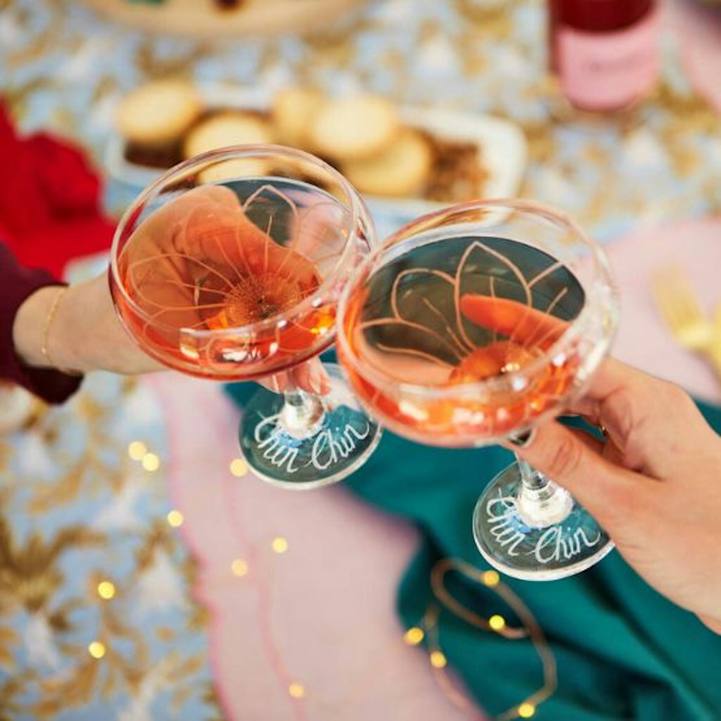 A pair of coupe champagne glasses with "chin chin" engraved on them
