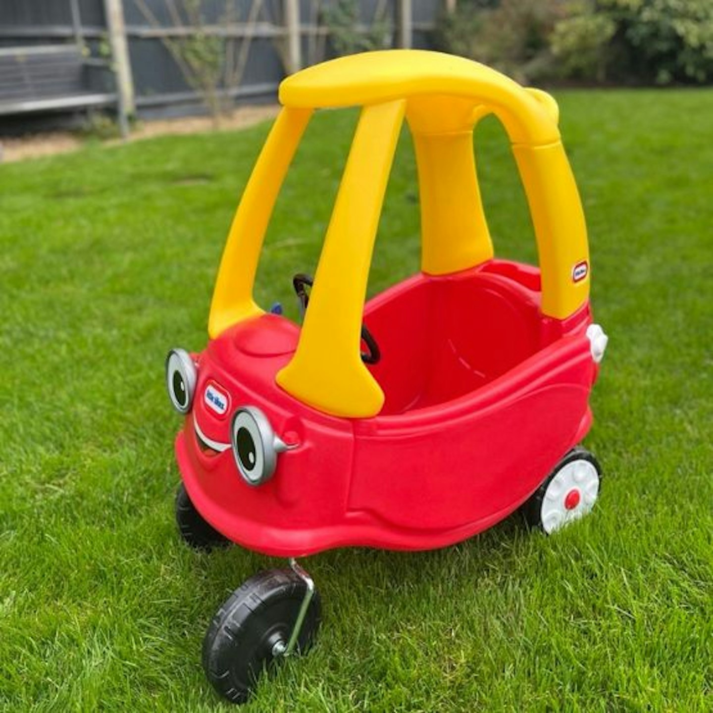 Little Tikes Cosy Coupe car being tested in a garden