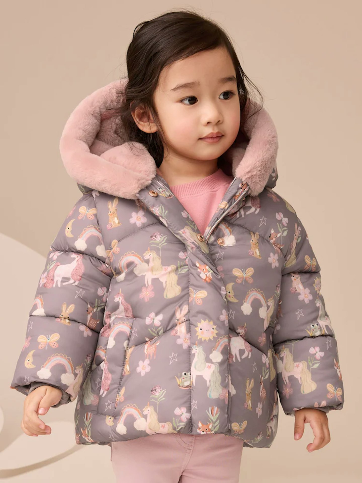 an image of a girl wearing a winter toddler coat with a unicorn print
