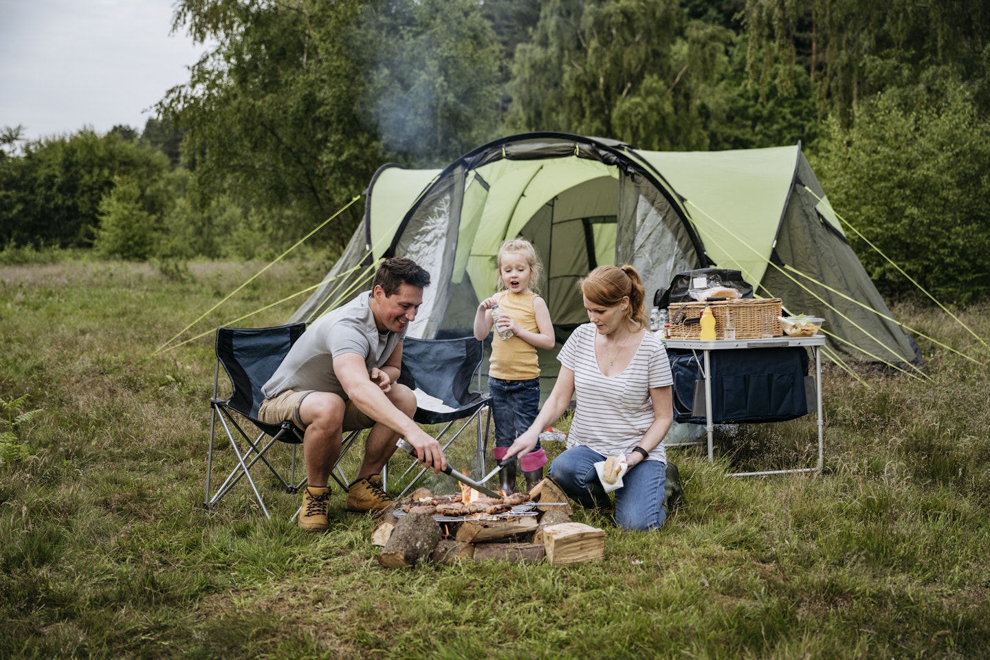A family camping in the outdoor to spend quality time together.