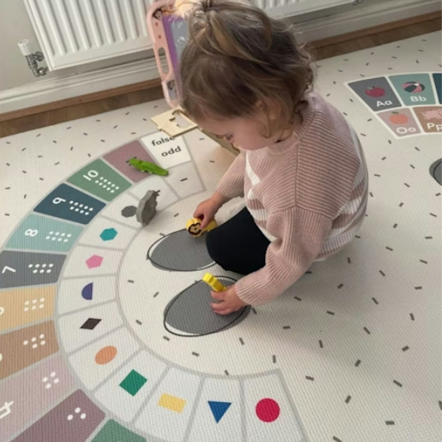 young girl sat down playing on the Rock Stepper Reversible Playmat