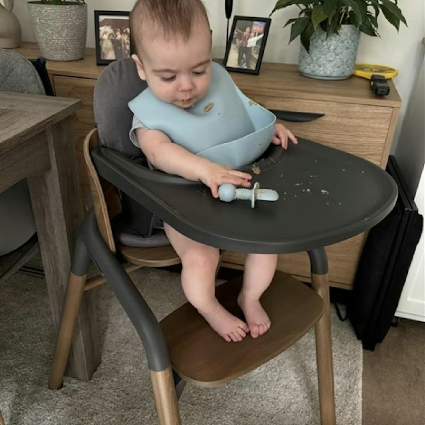 bugaboo giraffe high chair with a baby sitting inside