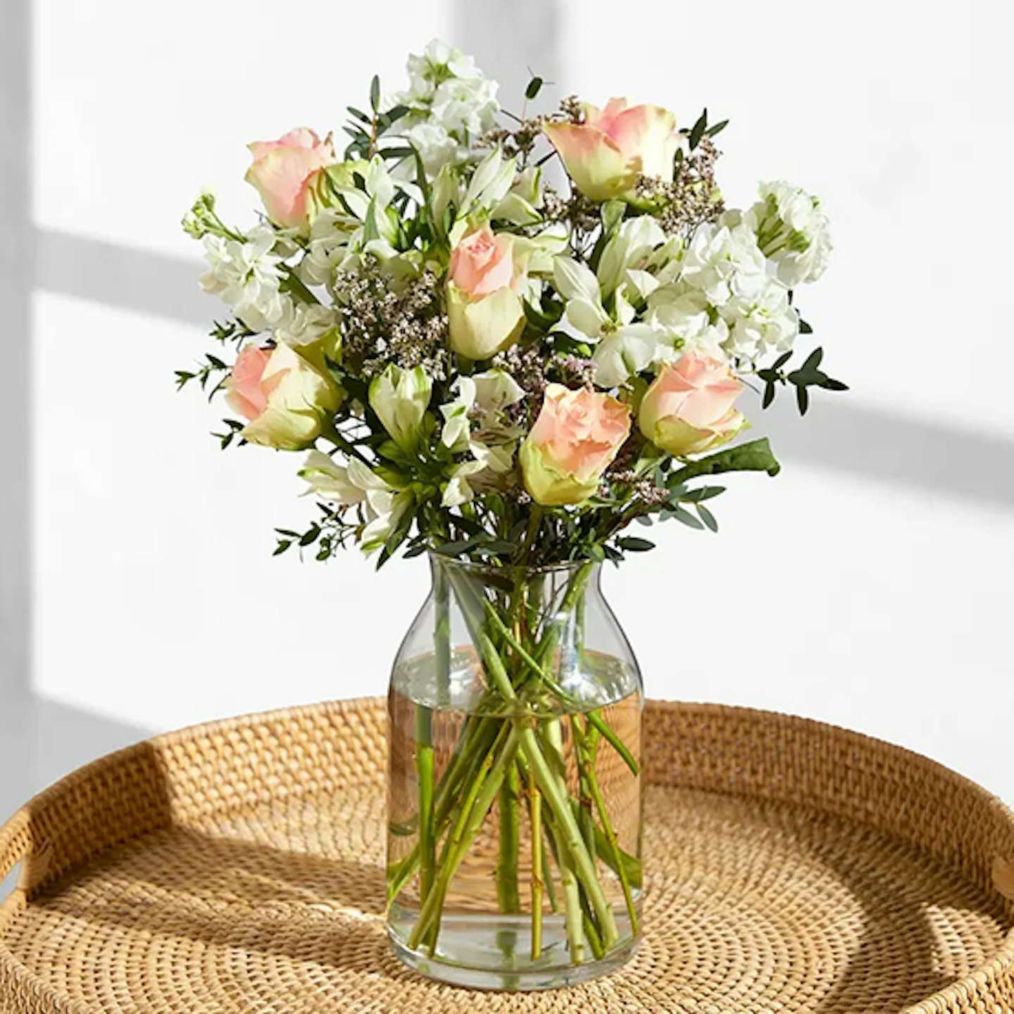 Pastel colours flowers in a vase on a table