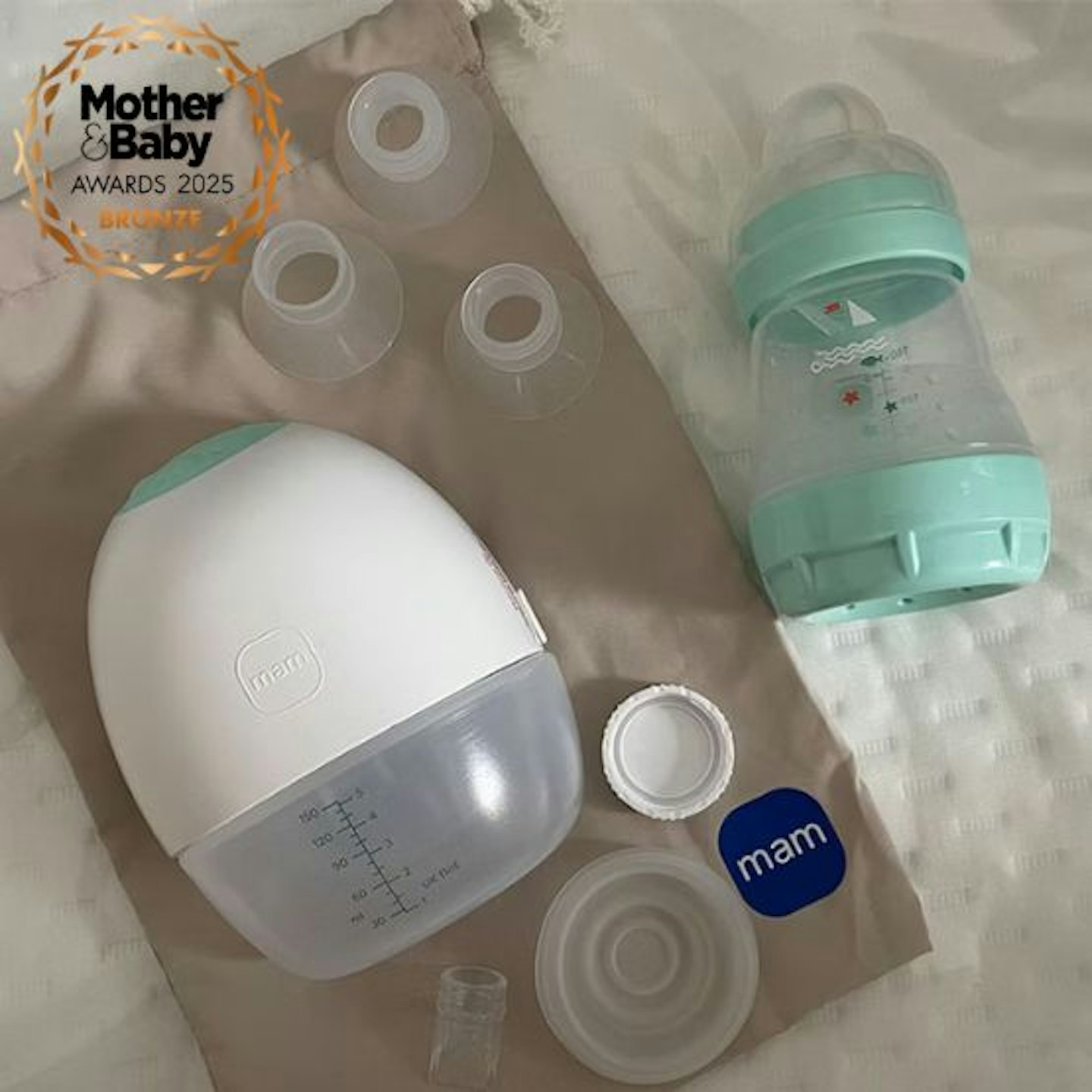 MAM Move Wearable Breast Pump laid out on the storage bag with a Mother&Baby Awrds 2025 Bronze winner logo