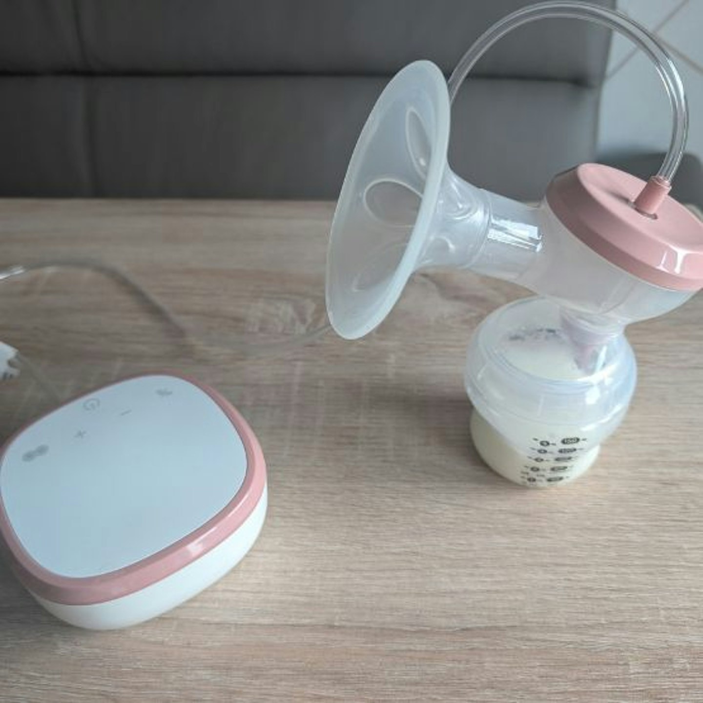 Tommee Tippee Made for Me Double Electric Breast Pump with the bottle filled with milk