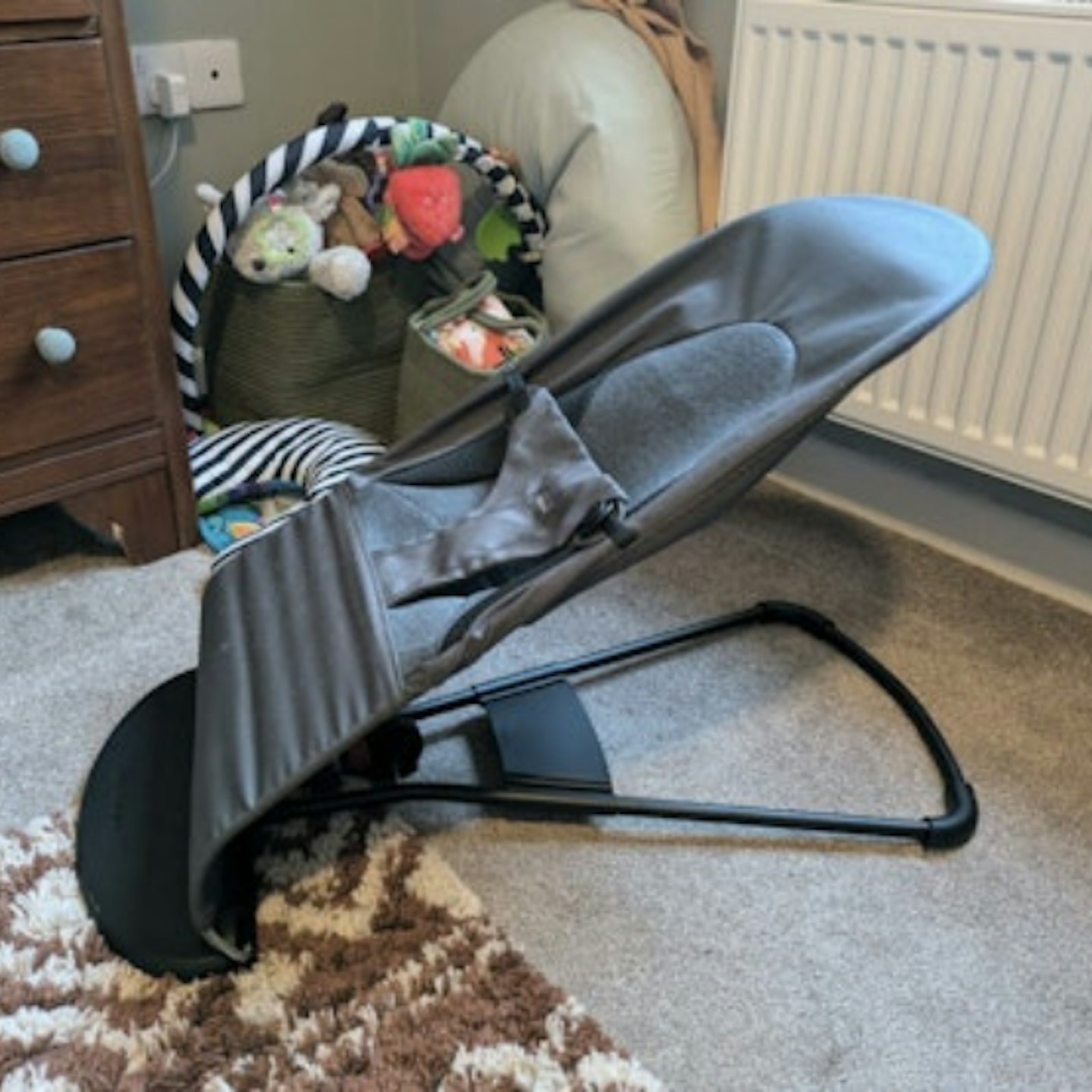 Dark grey baby bouncer in home setting