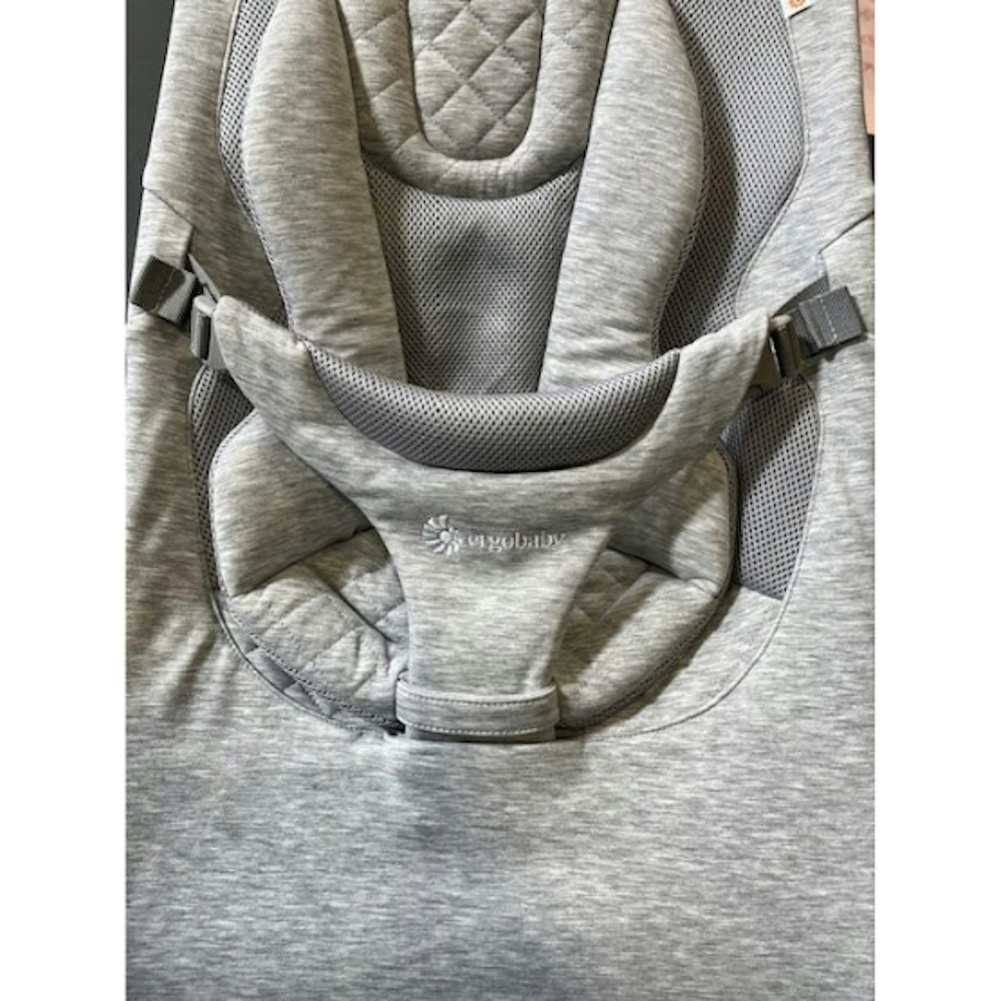 Close up of light grey baby bouncer