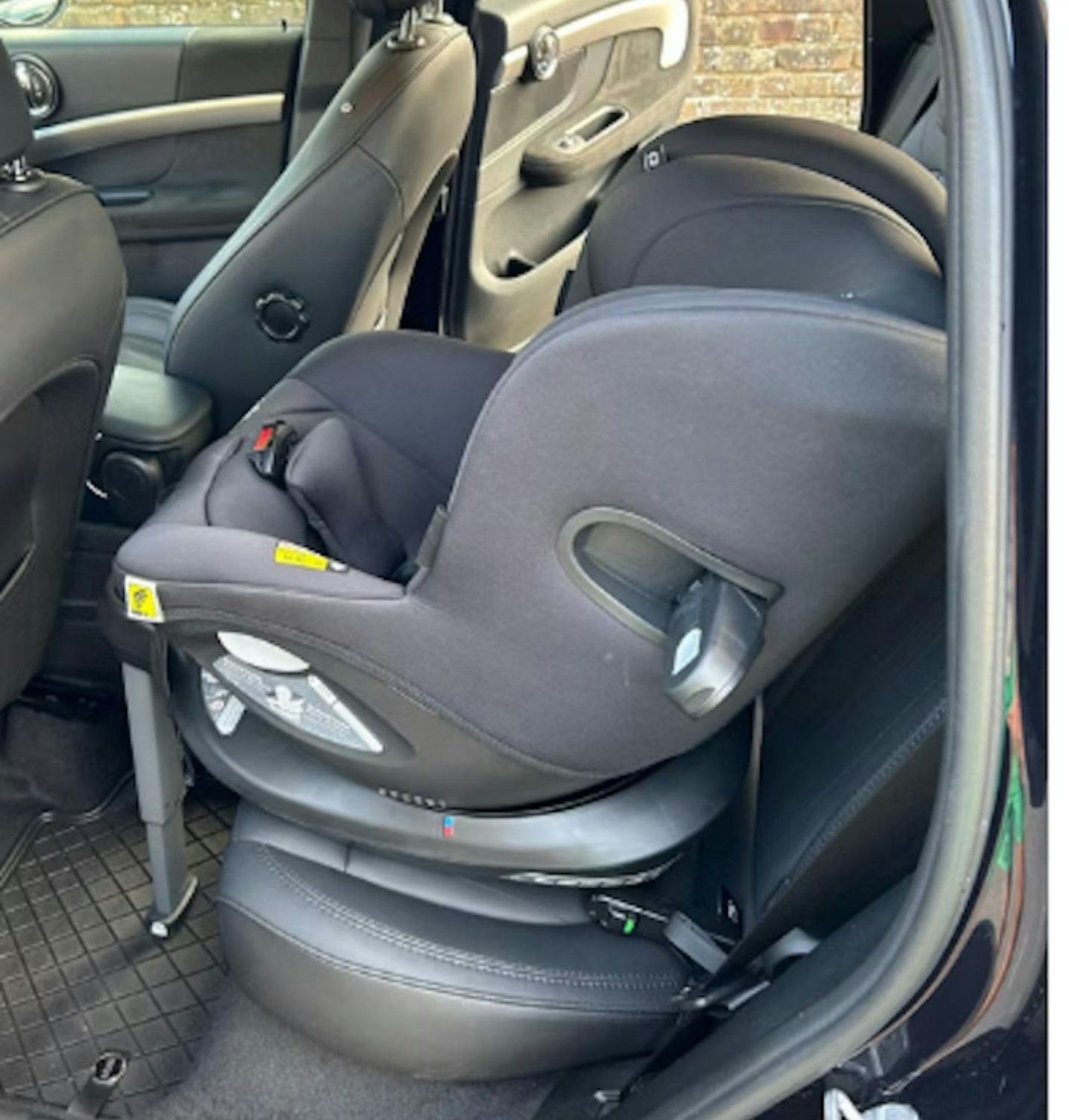 Joie Baby i-Spin 360 car seat show in the back seat of a car