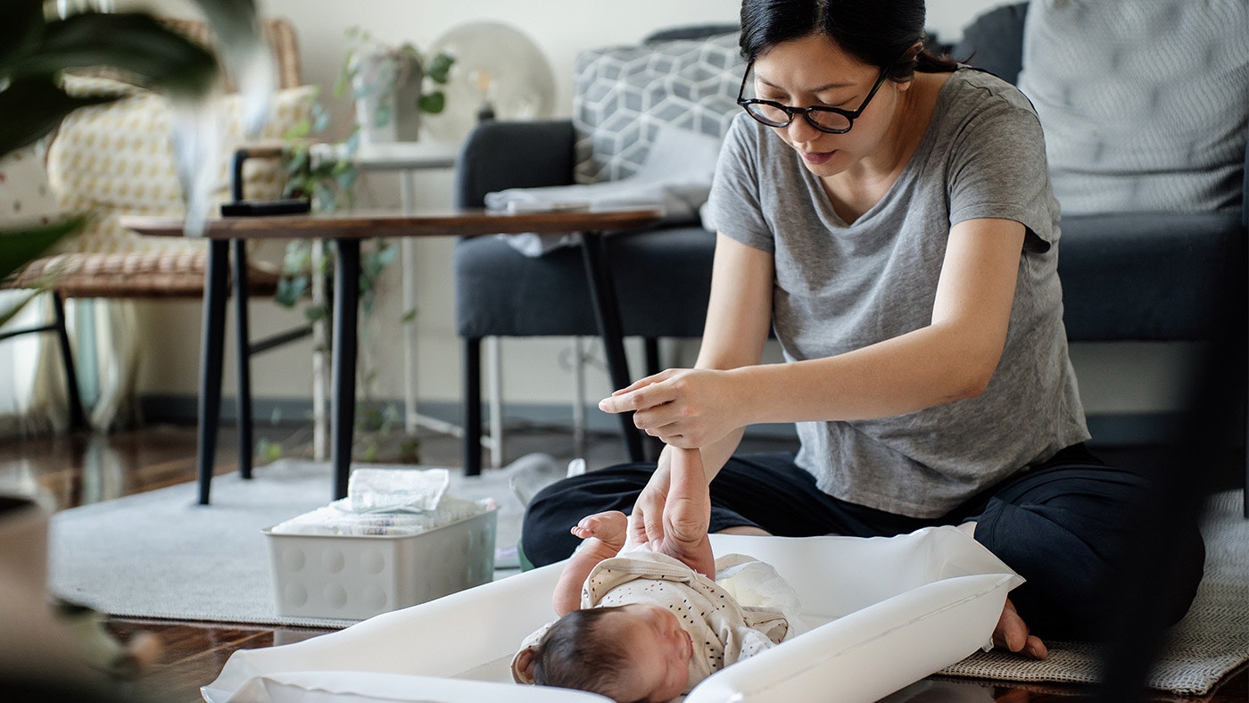 A mum changing her baby