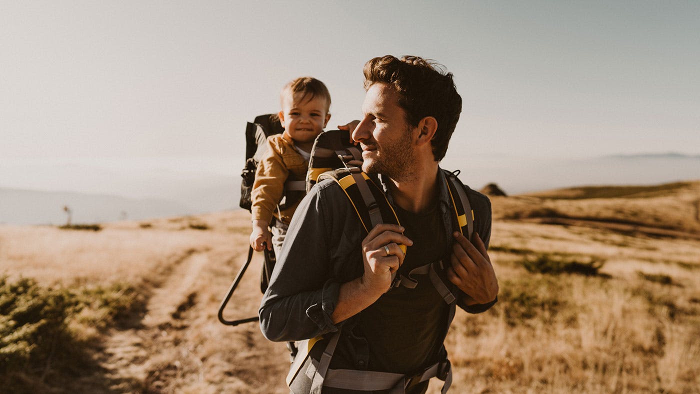 Dad carrying toddler on his back